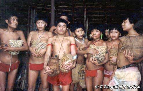 Survivors of the Haximu massacre, in which gold-miners killed 16 Yanomami Indians, hold urns containing the ashes of their relatives