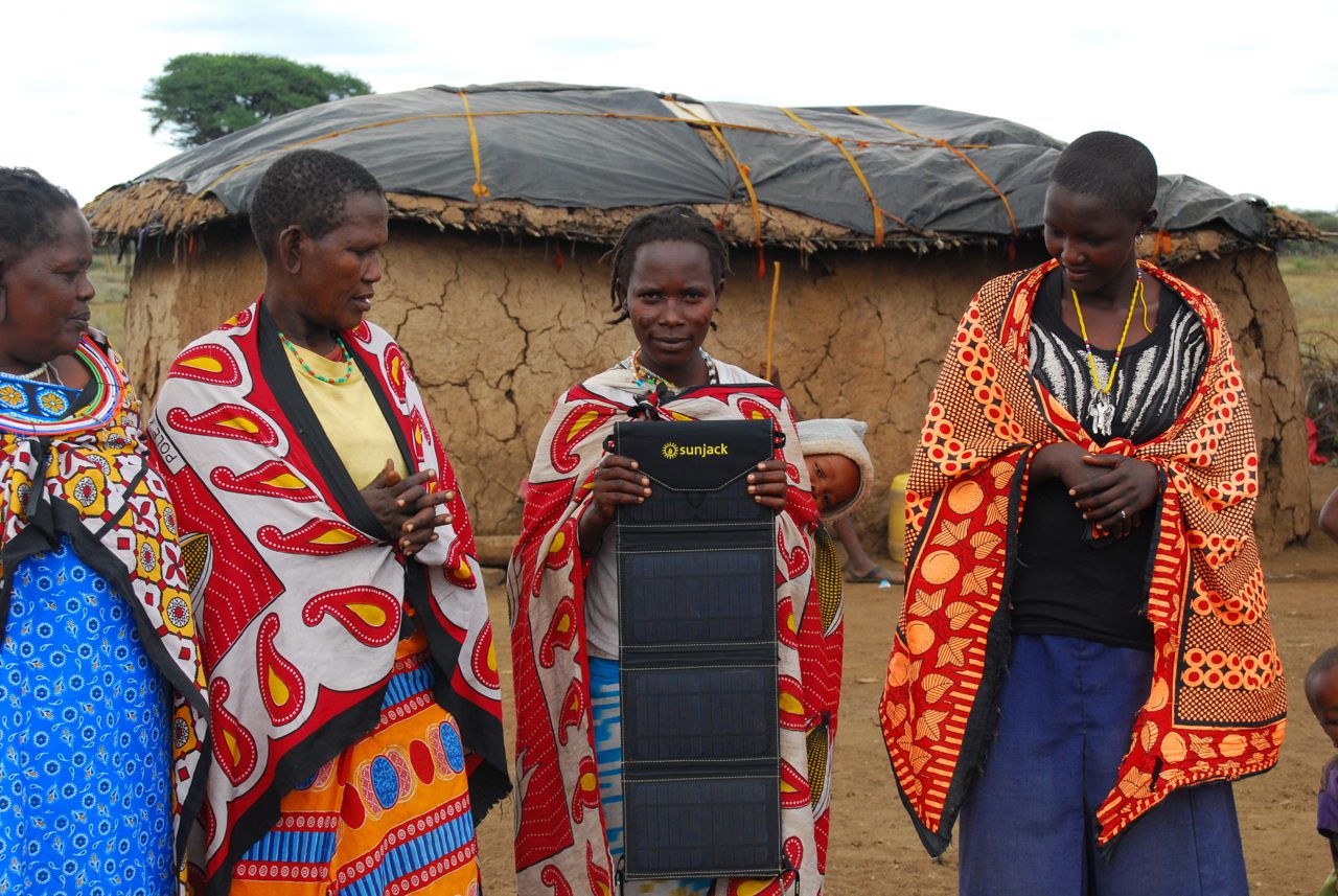 rural_african_villagers_holding_portable_solar_charger
